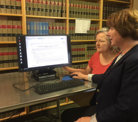two women in a law library looking at computers