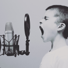 a kid yelling into a microphone