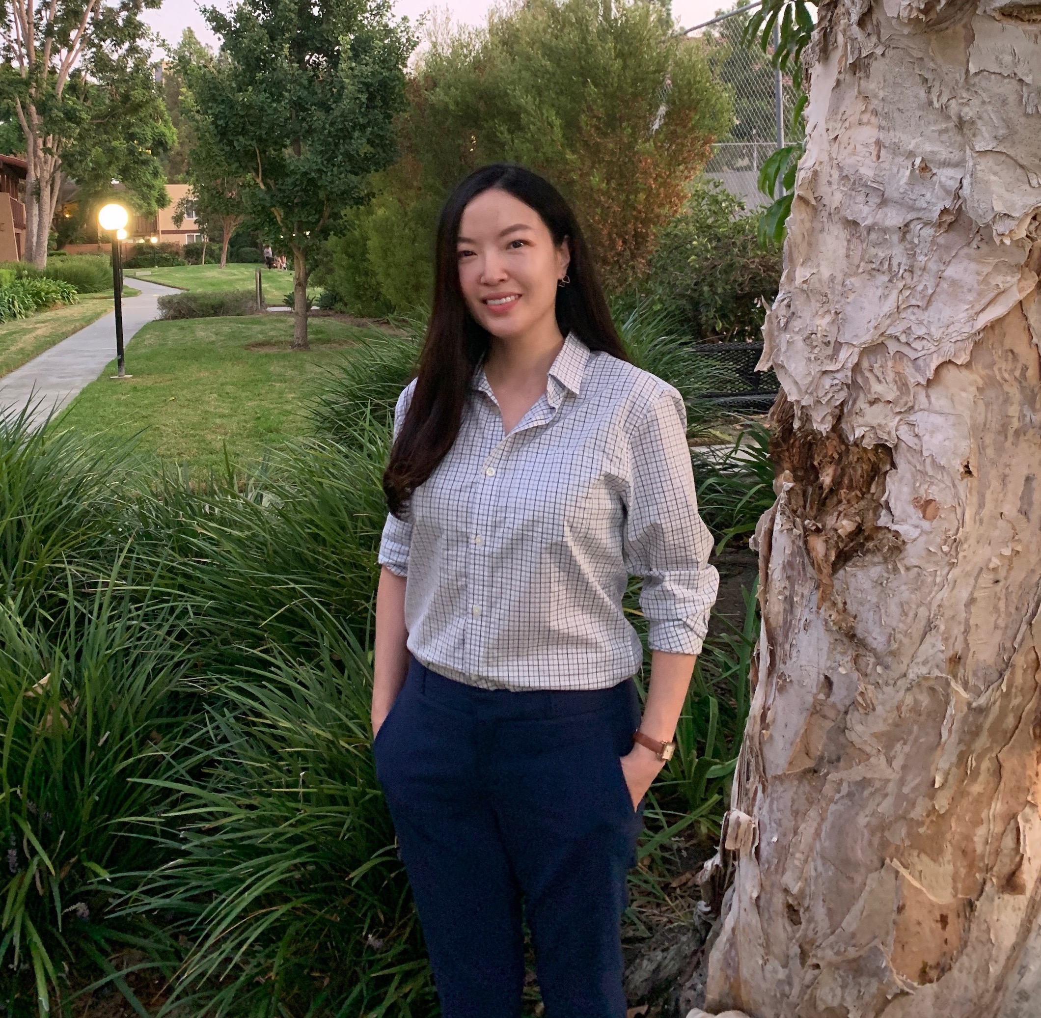 Ga Young Chung standing and smiling next to a tree