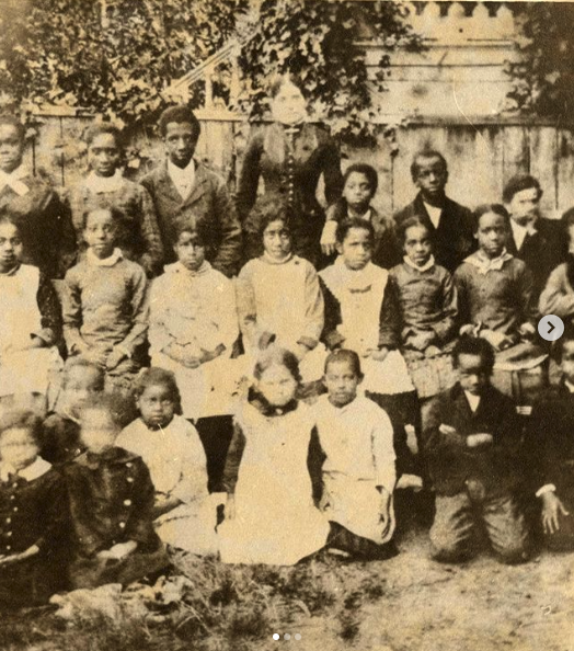 sepia photo of african american elementary school kids in class