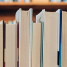 Stack of closed books facing towards the camera displaying its pages