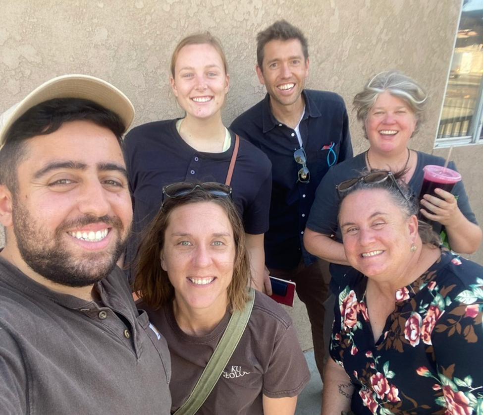 Six people (two Insight Garden Program facilitators and four members of the Center for Community and Citizen Science team) smile after an exciting and successful pilot at Avenal State Prison