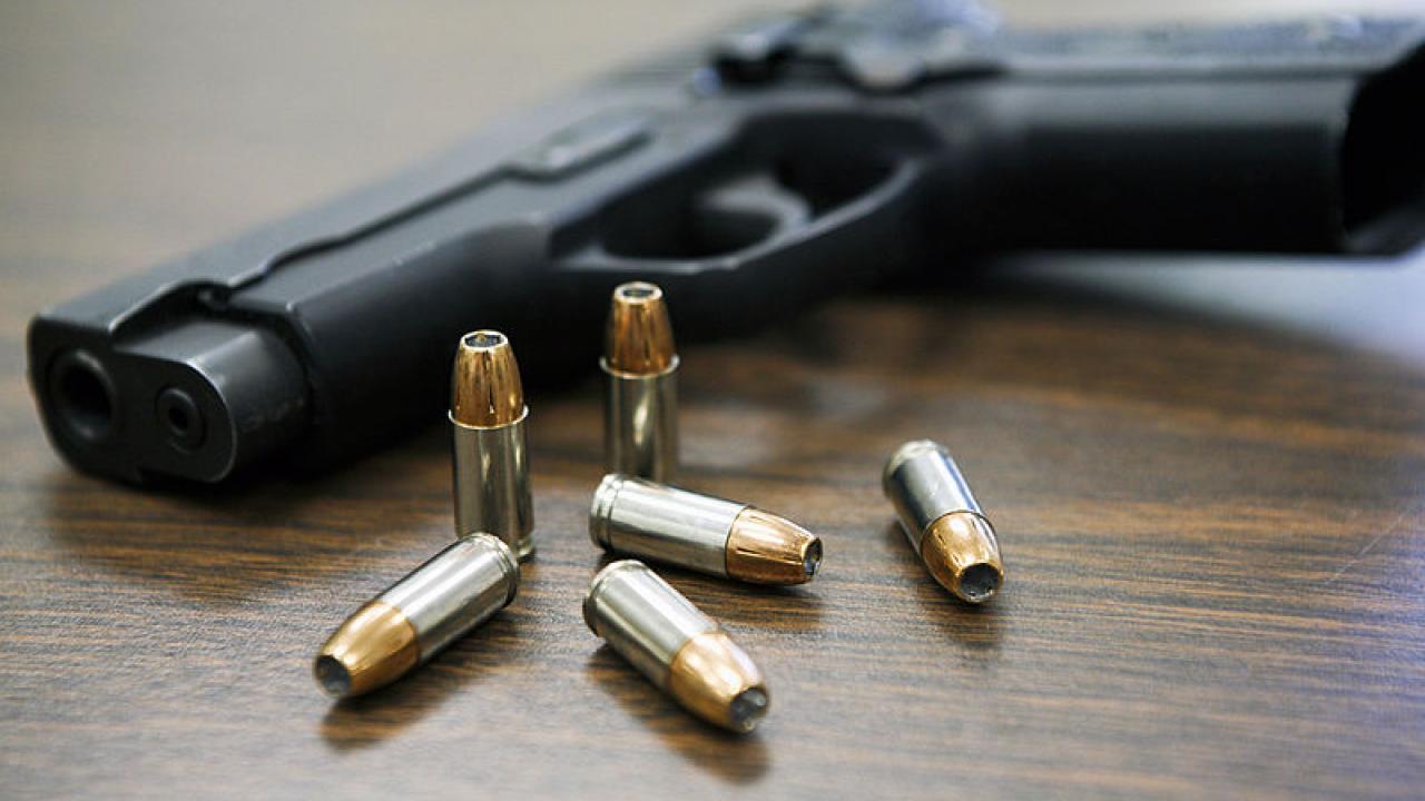 gun and bullets on a table