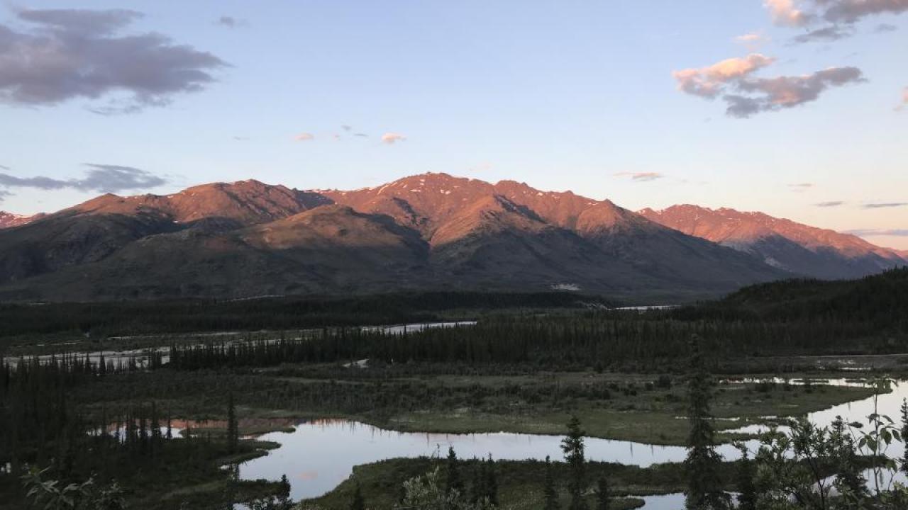 landscape with mountains and streams at sunset