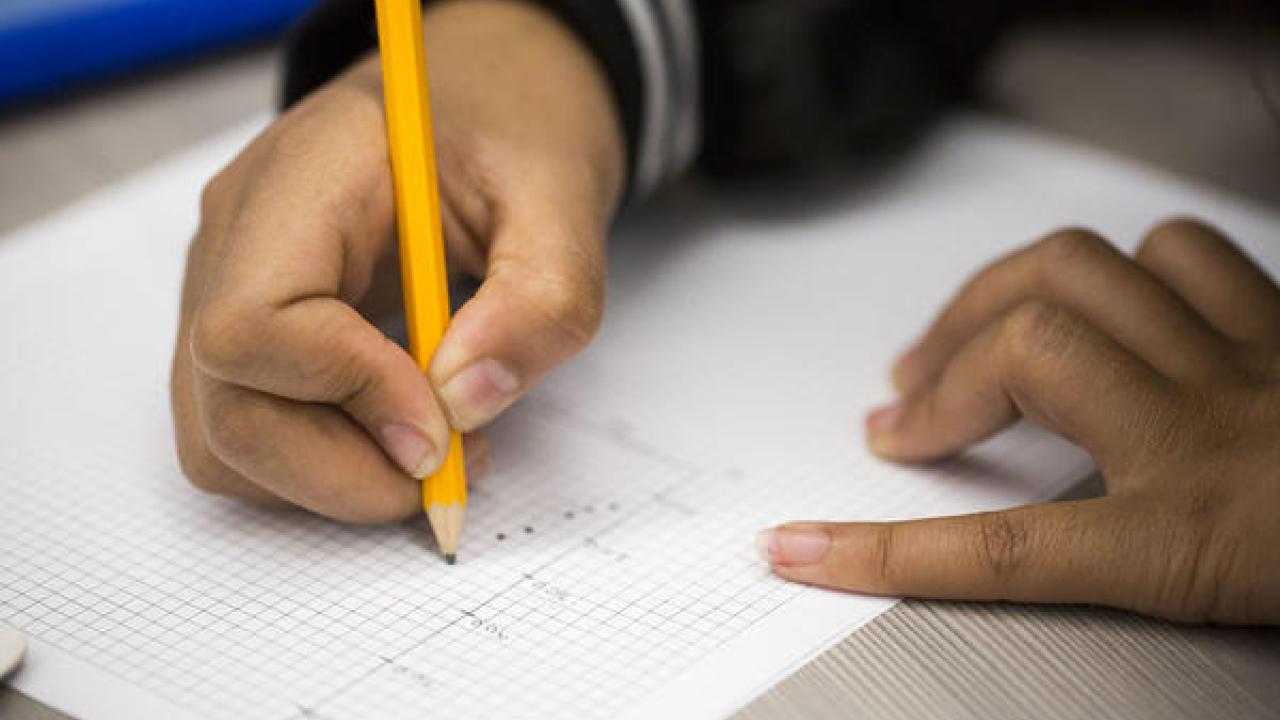 hand writing on a piece of paper 