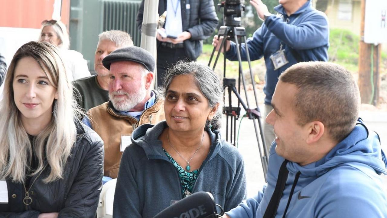 Entomologist researchers Julia Fine and Arathi Seshadri listen to the speakers at the grand opening of the USDA-ARS bee research facility in Davis. 