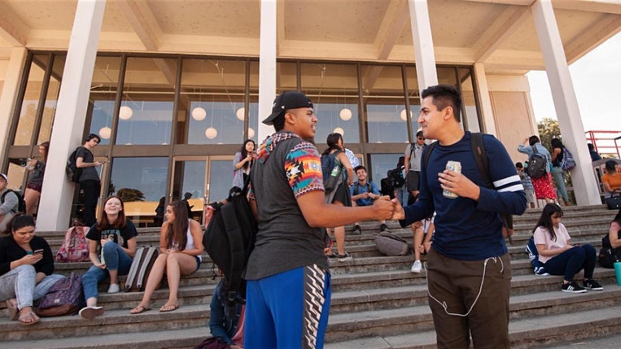 two men standing on the steps at rock hall shaking hands