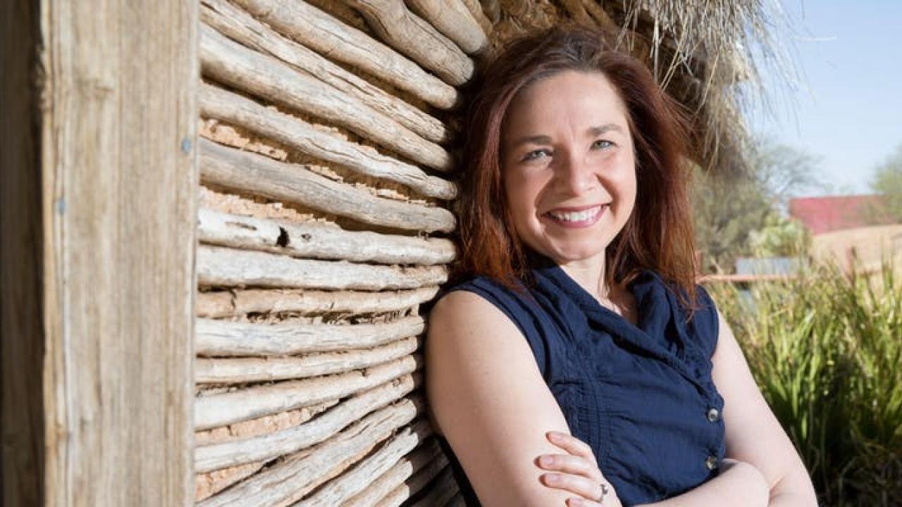 portrait of Katherine HayHoe leaning against a wall