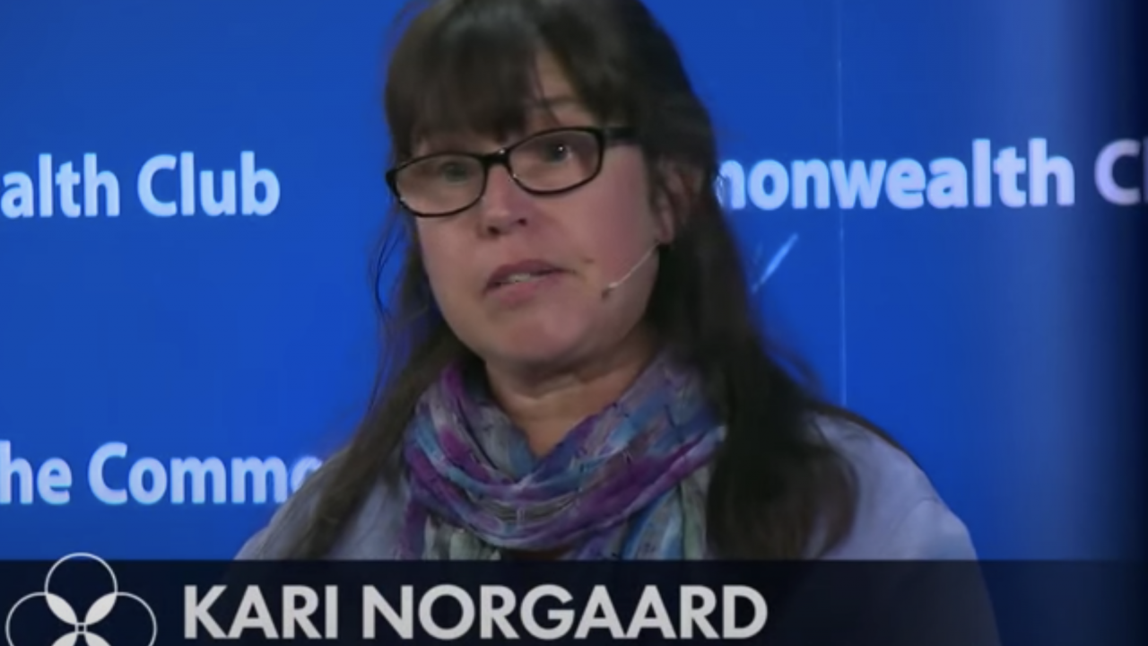 Dr. Kari Norgaard on a blue background