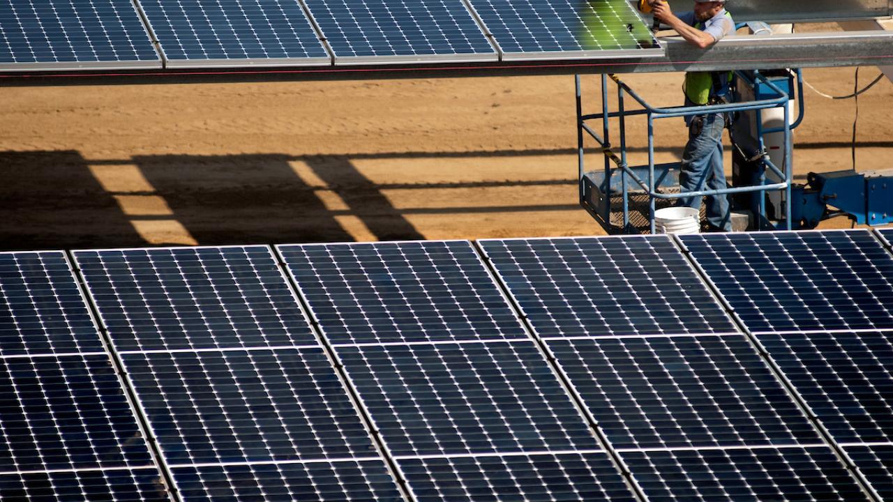 Man installs solar panel over parking lot