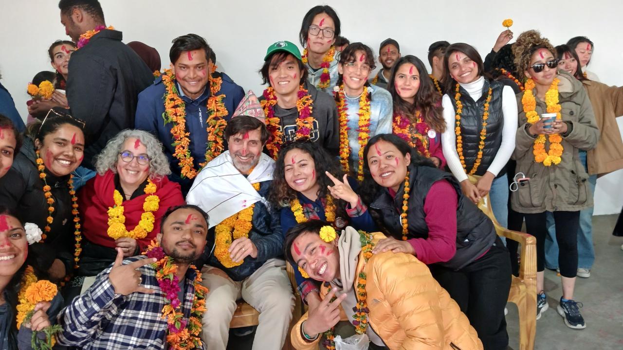 Professors Nancy Erbstein and Jonathan London surrounded by students in Nepal.