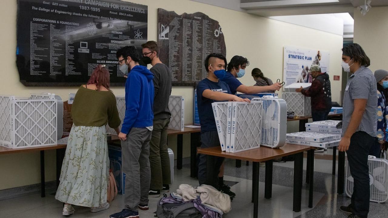 Students wearing masks in Kemper Hall showcase their air filters