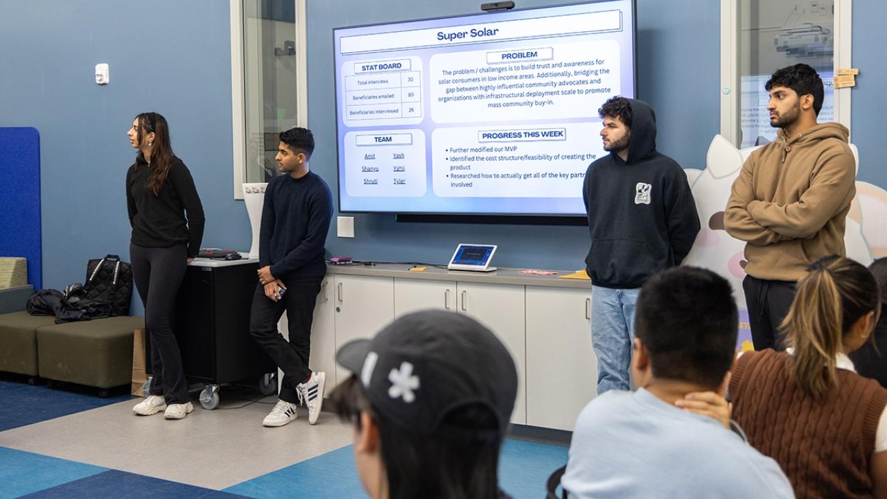 A group of students standing at the front of a classroom.