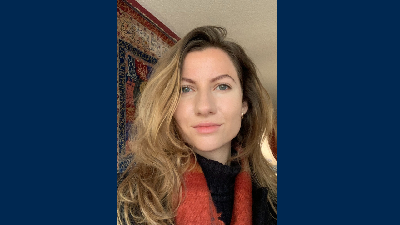 Meghan Zulian wears a colorful scarf and a black turtleneck
