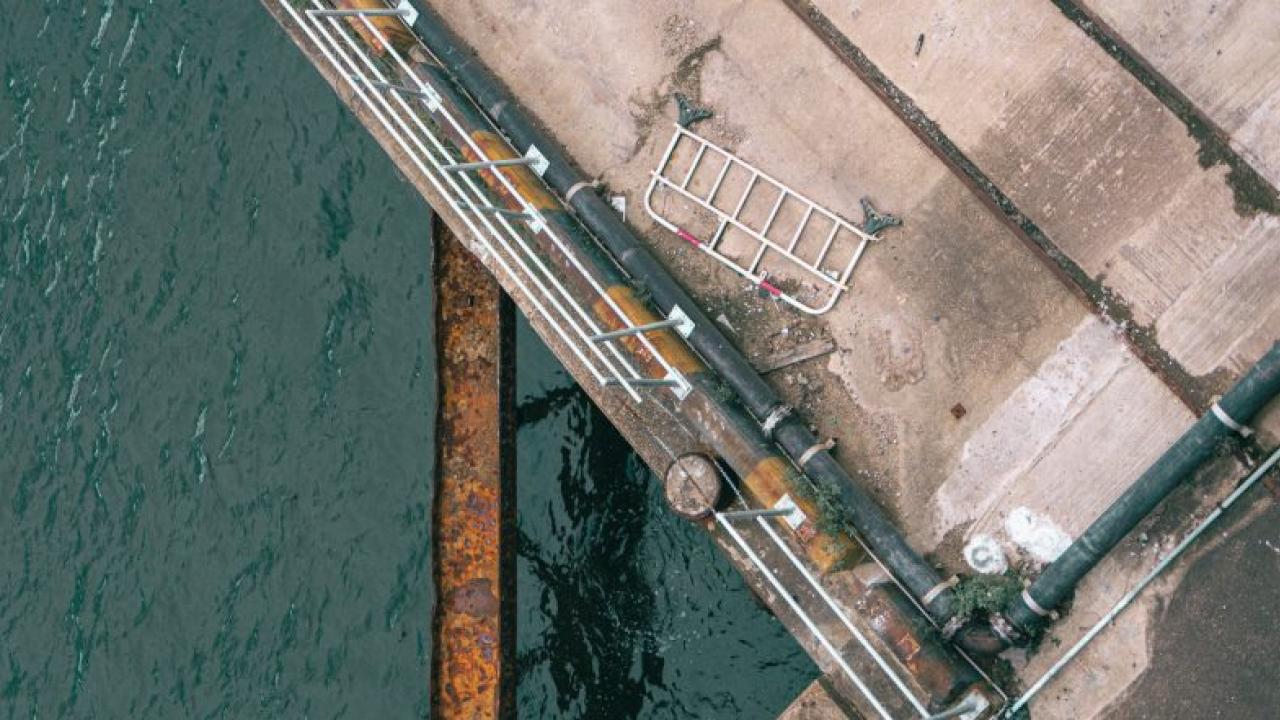 Close up aerial view of a port surrounded by a body of water