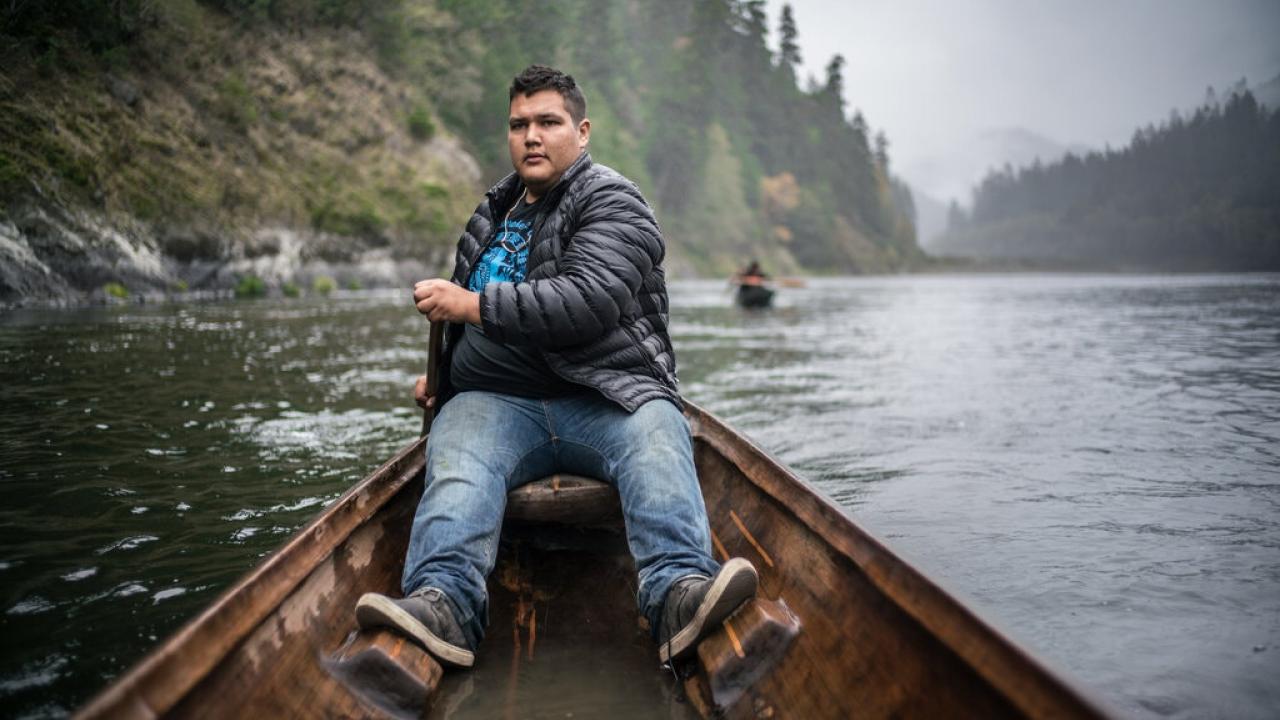 a man in a canoe rafting down the Klamath river