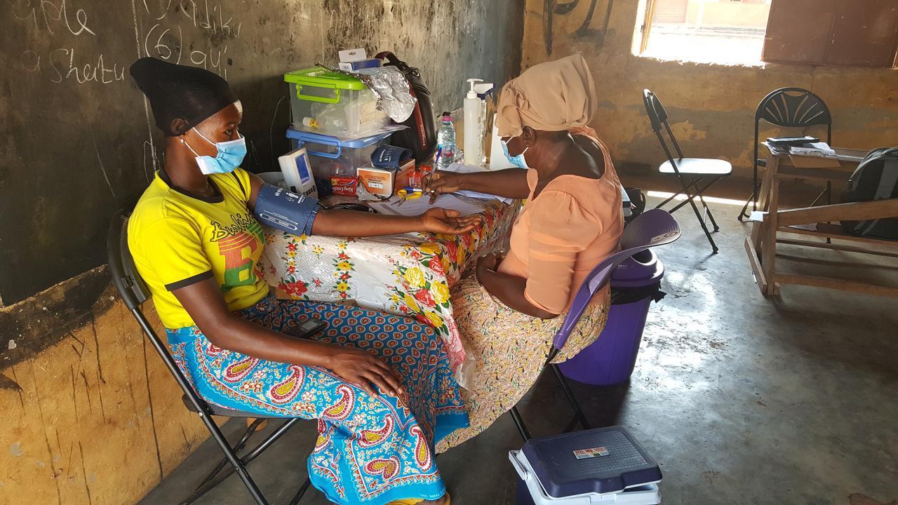 Medical workers collect data from participants in a study in Ghana.