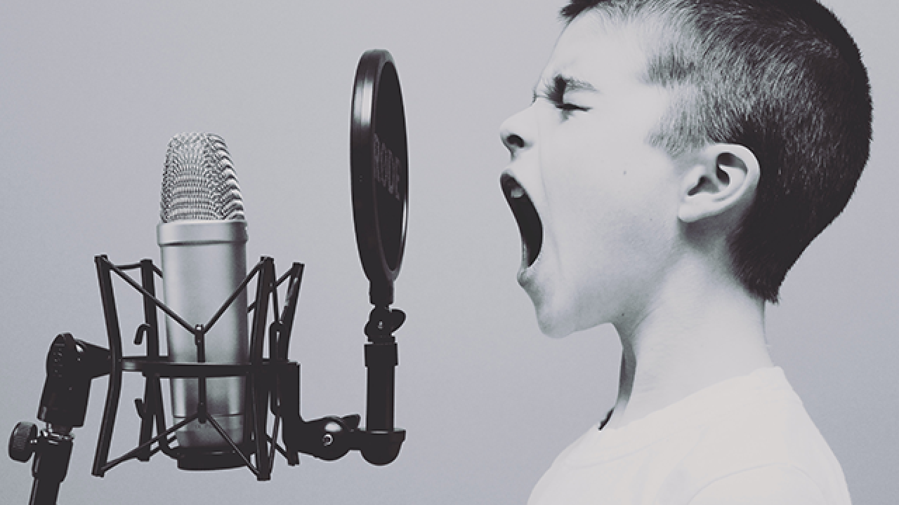 a kid yelling into a microphone