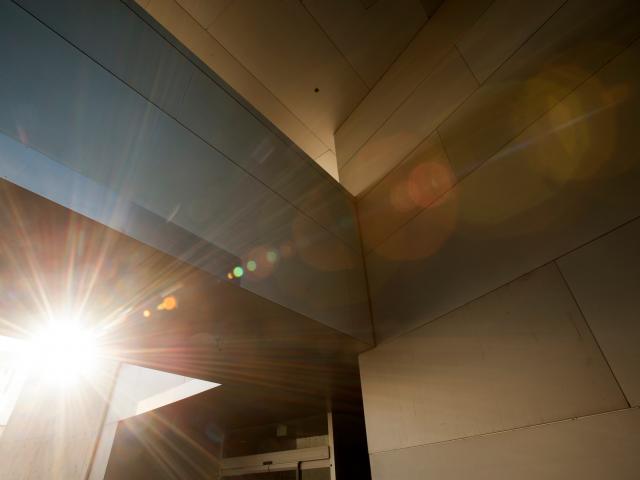 light shines through a concrete building 