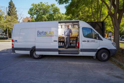 a man standing in front of the Beta Lab maker van