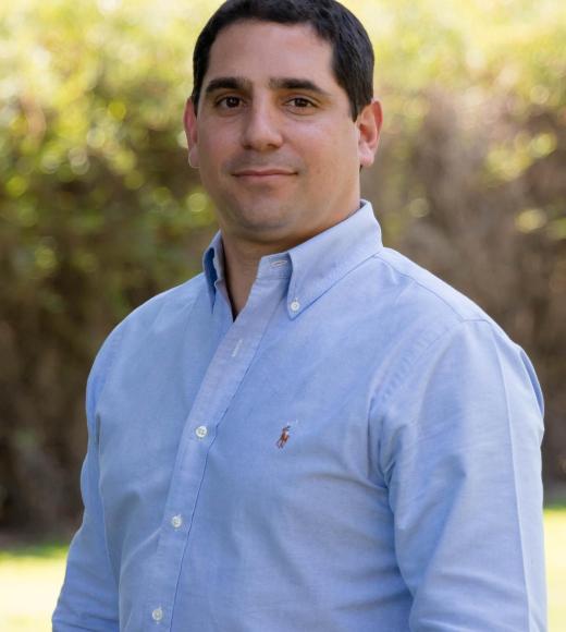 Miguel Jaller Martelo smiling while wearing a blue button up shirt