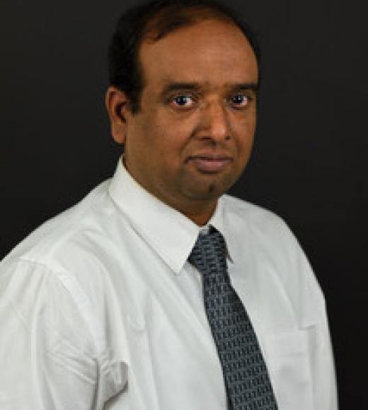 close up of a man looking forward in front of a plain background