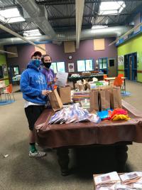 two young men wearing sweatshirts packing bags
