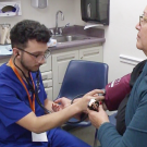man taking a woman's blood pressure