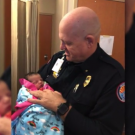 police officer holding a baby
