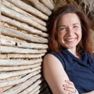 portrait of Katherine HayHoe leaning against a wall