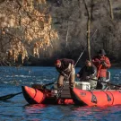 Yurok Tribal Fisheries members in red pontoon boat float Klamath River