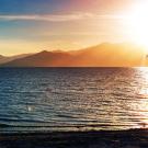 Sunset at the Salton Sea with mountains in the distance.