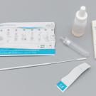 COVID-19 Antigen test kit laid out in front of a grey background