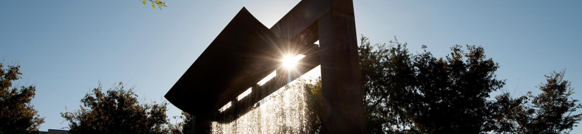 The sun sends streams of sunlight through water of the Morris Fountain in the Vanderhoef Quad on September 20, 2018. - Gregory Urquiaga