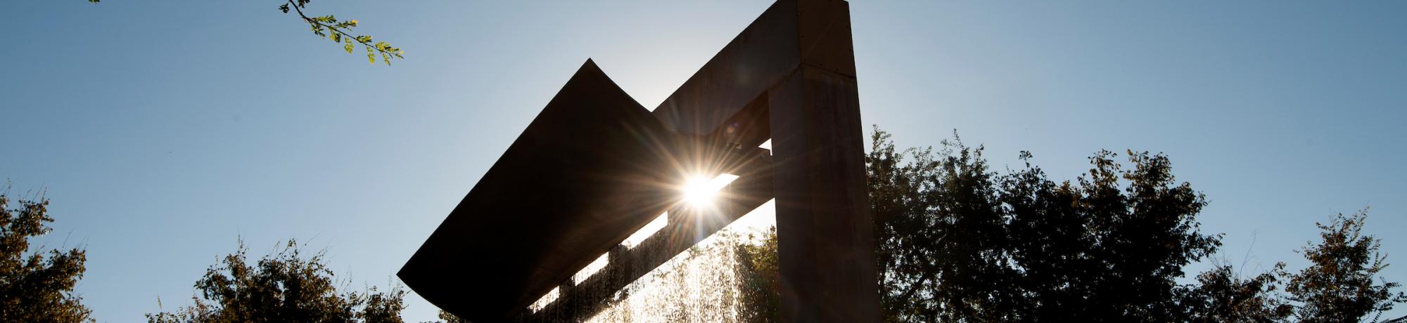 The sun sends streams of sunlight through water of the Morris Fountain in the Vanderhoef Quad on September 20, 2018. - Gregory Urquiaga
